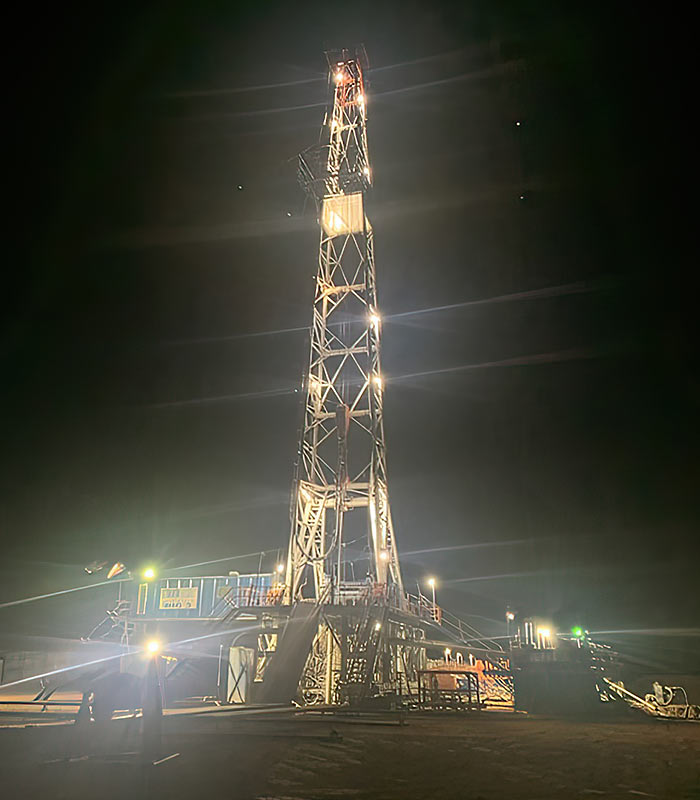 drilling oil well in Hqardeman Basin at night